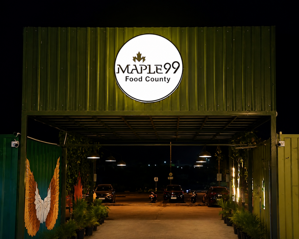 Mapple99 Food County entrance with illuminated sign and outdoor dining area