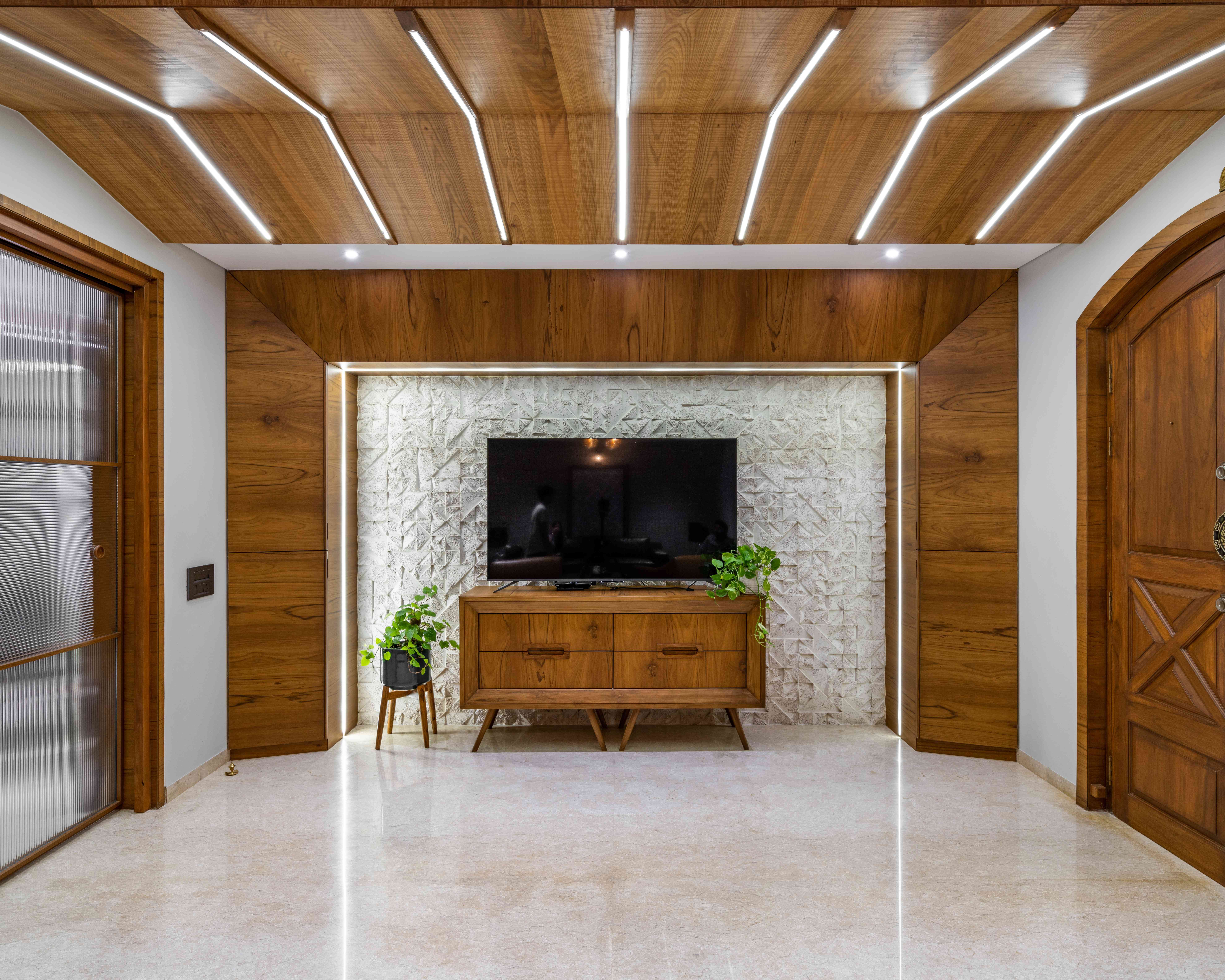 Casa Bellevue living room TV wall with wood paneling and textured feature wall